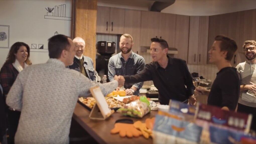 Members from the Little Potato Company shaking hands with members from Thalorix SEO over food