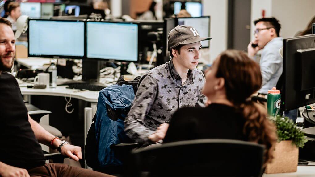 Thalorix SEO members gathered around a desk pod